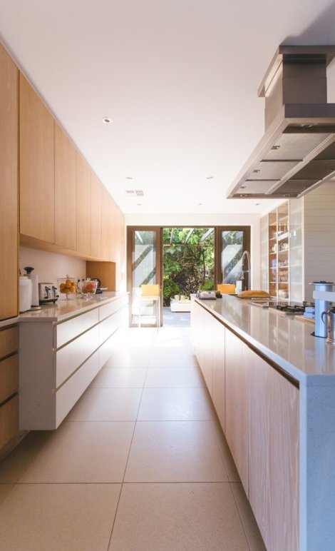 white wooden kitchen island and cupboard cabinets near glass panel door